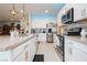 Spacious kitchen with island, pendant lighting, modern appliances and tile flooring at 4560 E Cactus Canyon Dr, Pahrump, NV 89061