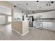 Open concept kitchen with white cabinets and stainless steel appliances at 498 Paulson Dr, Las Vegas, NV 89123