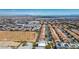 Expansive aerial view of a suburban neighborhood showcasing rows of single-Gathering homes under a clear blue sky at 5014 Thunder River Cir, Las Vegas, NV 89148