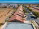 A high-angle view captures a residential street lined with neatly arranged homes featuring red tile roofs at 5014 Thunder River Cir, Las Vegas, NV 89148