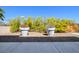 View of a backyard with low maintenance gravel area and a variety of potted plants at 5014 Thunder River Cir, Las Vegas, NV 89148