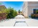 A backyard features a modern fire pit, landscaped plants, and a beautiful view at 5014 Thunder River Cir, Las Vegas, NV 89148