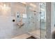 Modern bathroom featuring beautiful tile, a glass-enclosed shower, a sleek sink, and stylish fixtures at 5014 Thunder River Cir, Las Vegas, NV 89148