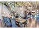 Dining area with table and chairs, open to the kitchen, stairs, and living spaces, offering a view of modern interiors at 5014 Thunder River Cir, Las Vegas, NV 89148