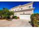 Attractive two-story home featuring mature landscaping and an attached two-car garage at 5014 Thunder River Cir, Las Vegas, NV 89148