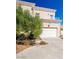 Beautiful two-story home featuring manicured landscaping and an attached two-car garage at 5014 Thunder River Cir, Las Vegas, NV 89148