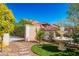 Charming front yard featuring a decorative fountain, lush landscaping, and a stone walkway to the entrance at 5014 Thunder River Cir, Las Vegas, NV 89148