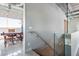 Stylish hallway with glass railing leading to an open office area featuring a large window and a modern desk at 5014 Thunder River Cir, Las Vegas, NV 89148