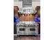 Modern kitchen boasts stainless steel Viking range, custom backsplash, and sleek dark cabinetry at 5014 Thunder River Cir, Las Vegas, NV 89148