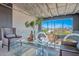 Inviting living room with city views, stylish seating, glass coffee table, and a unique chandelier fixture at 5014 Thunder River Cir, Las Vegas, NV 89148
