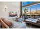 Bright living room featuring large windows, a plush sectional sofa, and modern decor for a comfortable and stylish living space at 5014 Thunder River Cir, Las Vegas, NV 89148