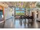 Open-concept living area featuring industrial ceilings, chandeliers, and a dining space with views of the surrounding greenery at 5014 Thunder River Cir, Las Vegas, NV 89148