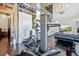 Open-concept living area with exercise equipment, luxurious marble, and stylish furnishings, ideal for modern living at 5014 Thunder River Cir, Las Vegas, NV 89148