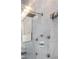 Close-up of modern shower fixtures and marble tile, alongside a silver sink and bright vanity lights at 5014 Thunder River Cir, Las Vegas, NV 89148