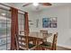 Dining area filled with natural light, featuring a ceiling fan and sliding glass doors at 5465 Cardinal Ridge Ct # 103, Las Vegas, NV 89149