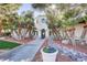 Inviting front entrance with lush landscaping and a well-manicured lawn at 5465 Cardinal Ridge Ct # 103, Las Vegas, NV 89149