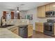 This bright kitchen features stainless steel appliances and wood-look flooring at 5465 Cardinal Ridge Ct # 103, Las Vegas, NV 89149