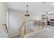 View of the landing at the top of the carpeted stairs with chandelier at 5465 Cardinal Ridge Ct # 103, Las Vegas, NV 89149