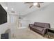 This is an upstairs living room with a brown couch and ceiling fan at 5465 Cardinal Ridge Ct # 103, Las Vegas, NV 89149