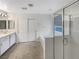 Bathroom with double vanity, glass shower, and neutral tile at 6228 Grace Mountain St, Las Vegas, NV 89115