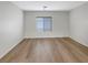 Well lit bedroom featuring hardwood floors, neutral paint, and bright windows with ample natural light at 6228 Grace Mountain St, Las Vegas, NV 89115