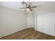 Bright bedroom featuring a ceiling fan, wood floors and a closet with white doors at 6228 Grace Mountain St, Las Vegas, NV 89115