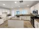 Bright kitchen features white cabinets, granite countertops and a center island at 6228 Grace Mountain St, Las Vegas, NV 89115