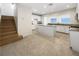 Bright kitchen features white cabinets, granite countertops and a center island at 6228 Grace Mountain St, Las Vegas, NV 89115