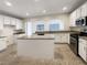 Bright kitchen features white cabinets, granite countertops and a center island at 6228 Grace Mountain St, Las Vegas, NV 89115