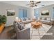 Bright living room featuring modern decor, plush seating, and a stylish ceiling fan with views from the large window at 6228 Grace Mountain St, Las Vegas, NV 89115