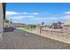 Backyard includes stone landscaping, lounge chairs, an outdoor seating area, and a fenced in grass area at 6232 Lautman Ridge Ct, Las Vegas, NV 89141