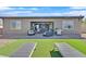 Well-maintained backyard with patio, outdoor furniture, lounge chairs, and desert landscaping for relaxation and entertainment at 6232 Lautman Ridge Ct, Las Vegas, NV 89141