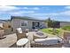 A backyard featuring an outdoor seating area, a fireplace, and a manicured lawn at 6232 Lautman Ridge Ct, Las Vegas, NV 89141