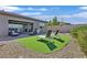 Backyard featuring a synthetic lawn, lounge chairs, and patio at 6232 Lautman Ridge Ct, Las Vegas, NV 89141