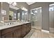 Modern bathroom with a double vanity, framed mirror, and glass-enclosed shower at 6232 Lautman Ridge Ct, Las Vegas, NV 89141