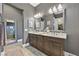 Elegant bathroom featuring double sinks, a large mirror, and a spacious walk-in shower at 6232 Lautman Ridge Ct, Las Vegas, NV 89141