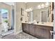 Bathroom with double vanity, modern lighting, and decorative artwork above at 6232 Lautman Ridge Ct, Las Vegas, NV 89141