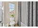 Bathroom with a toilet beside a window and a shower/bath with patterned curtains at 6232 Lautman Ridge Ct, Las Vegas, NV 89141