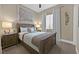 Cozy bedroom featuring a bed, nightstand, and soft, neutral colors throughout at 6232 Lautman Ridge Ct, Las Vegas, NV 89141