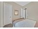 Well-lit bedroom featuring neutral tones, simple decor, and carpeted floors at 6232 Lautman Ridge Ct, Las Vegas, NV 89141