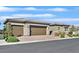 Beautiful home featuring a three-car garage and a well-maintained brick driveway at 6232 Lautman Ridge Ct, Las Vegas, NV 89141