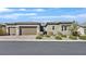 Charming single-story home featuring a three-car garage and beautifully landscaped front yard at 6232 Lautman Ridge Ct, Las Vegas, NV 89141