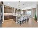 Elegant kitchen island with granite countertops, pendant lights, stainless appliances, and breakfast bar seating at 6232 Lautman Ridge Ct, Las Vegas, NV 89141