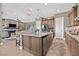 Gourmet kitchen featuring granite island with seating, stainless appliances, gas cooktop, and open layout to living area at 6232 Lautman Ridge Ct, Las Vegas, NV 89141