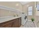 Bright laundry room with modern appliances, ample counter space, and neutral decor at 6232 Lautman Ridge Ct, Las Vegas, NV 89141