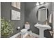 Stylish powder room with vessel sink, wood-look tile, and modern accents at 6232 Lautman Ridge Ct, Las Vegas, NV 89141
