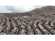 Scenic aerial view of the neighborhood showcasing the homes, streets, and mountain views in the distance at 6394 Wild Strawberry Ln, Las Vegas, NV 89142