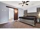 Spacious bedroom featuring a ceiling fan, carpet, a sliding barn door and neutral paint at 7156 N Campbell Rd, Las Vegas, NV 89149