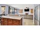 Open kitchen design featuring stainless steel appliances, granite countertops, and a view of the living room at 7156 N Campbell Rd, Las Vegas, NV 89149