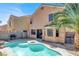 Backyard pool with a barbecue, a palm tree, and a two-story home with neutral-colored siding at 7156 N Campbell Rd, Las Vegas, NV 89149